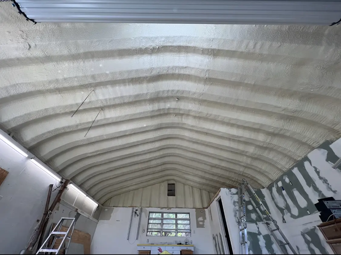 Spray polyurethane foam applied to the underside of a metal roof deck in Dover